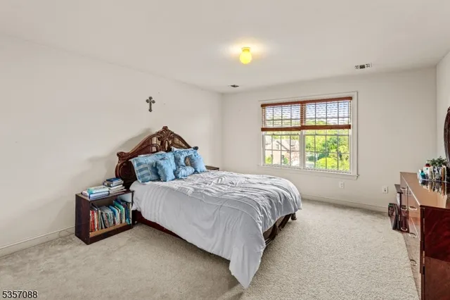 a bed sitting in a bedroom next to a window