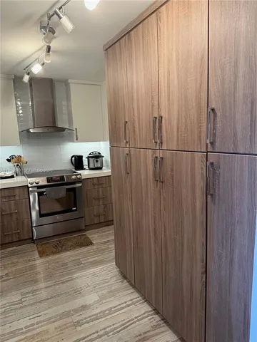 a kitchen with kitchen island a sink stainless steel appliances and cabinets