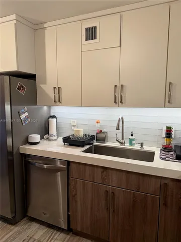 a kitchen with a sink a stove and cabinets
