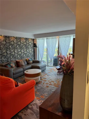 a living room with furniture and a large window