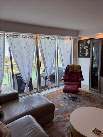 a living room with a couch and a potted plant