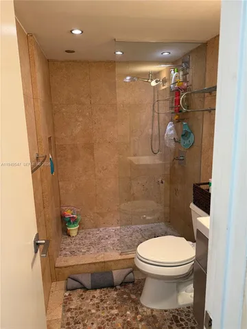a bathroom with a toilet and a shower