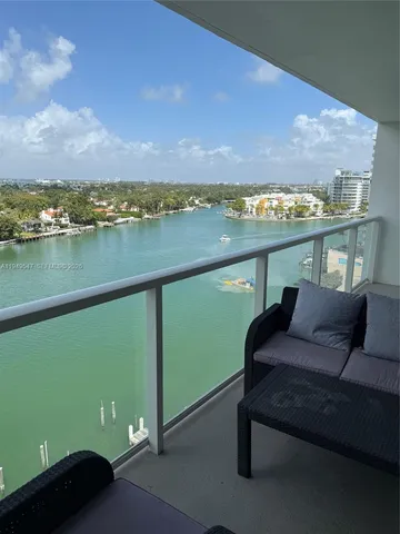 a terrace with outdoor seating and lake view