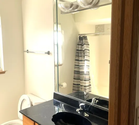 a view of a bathroom with shower and a window