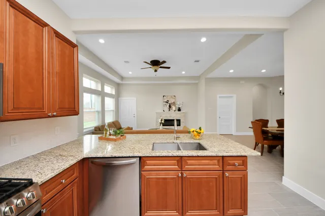 a kitchen with stainless steel appliances granite countertop a sink stove and refrigerator