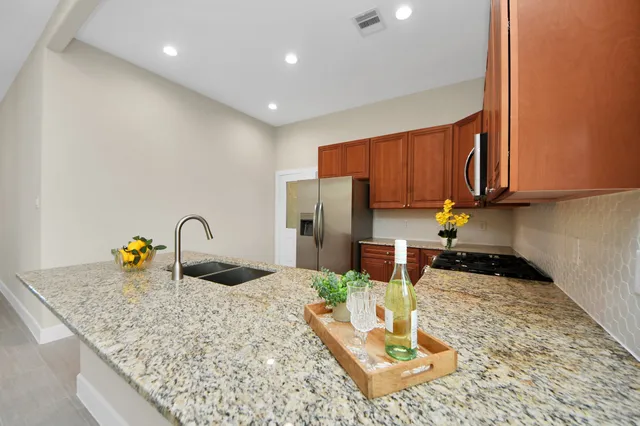 a kitchen with sink refrigerator and cabinets
