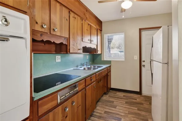 a kitchen with stainless steel appliances granite countertop a refrigerator and a sink