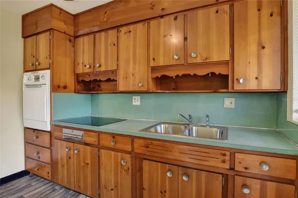 a kitchen with stainless steel appliances granite countertop white cabinets and a sink