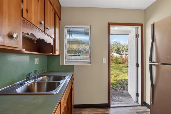 a kitchen with sink and cabinets