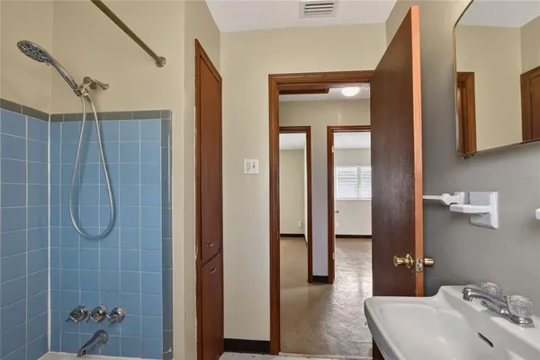 a bathroom with a shower and a sink