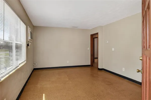 a view of an empty room with a window