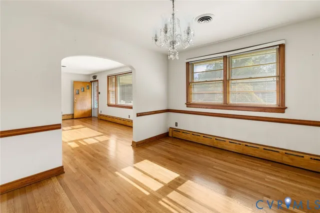 wooden floor in an empty room with a window