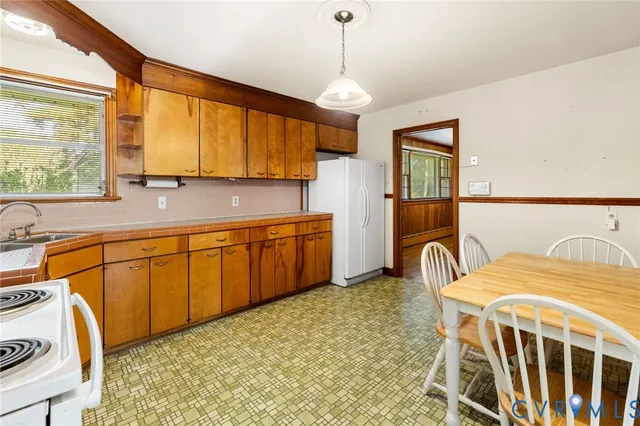 a kitchen with stainless steel appliances granite countertop a sink a stove and a refrigerator