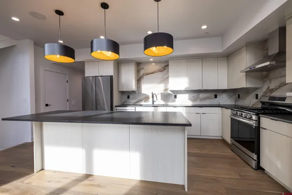 a view of a hallway with wooden floor and a fireplace