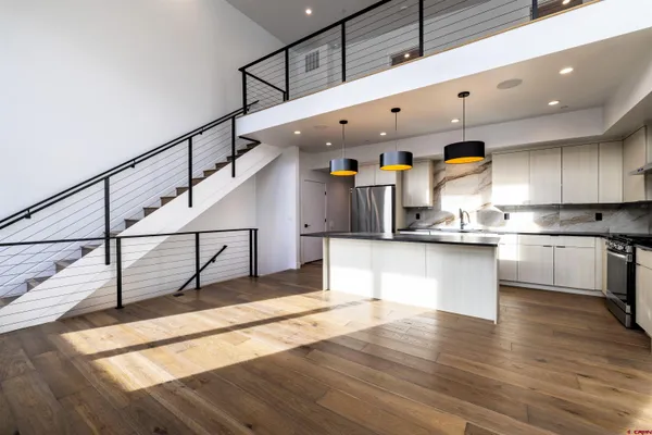 a kitchen with a sink a stove and cabinets