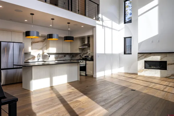 a kitchen with a stove cabinets and a wooden floor