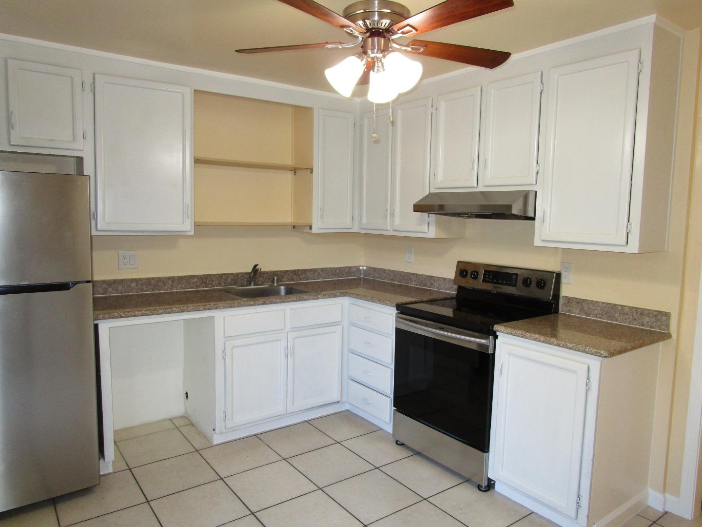 7759 Murray Avenue Gilroy, CA 95020 - Photo 4 of 11 a kitchen with granite countertop white cabinets and white appliances
