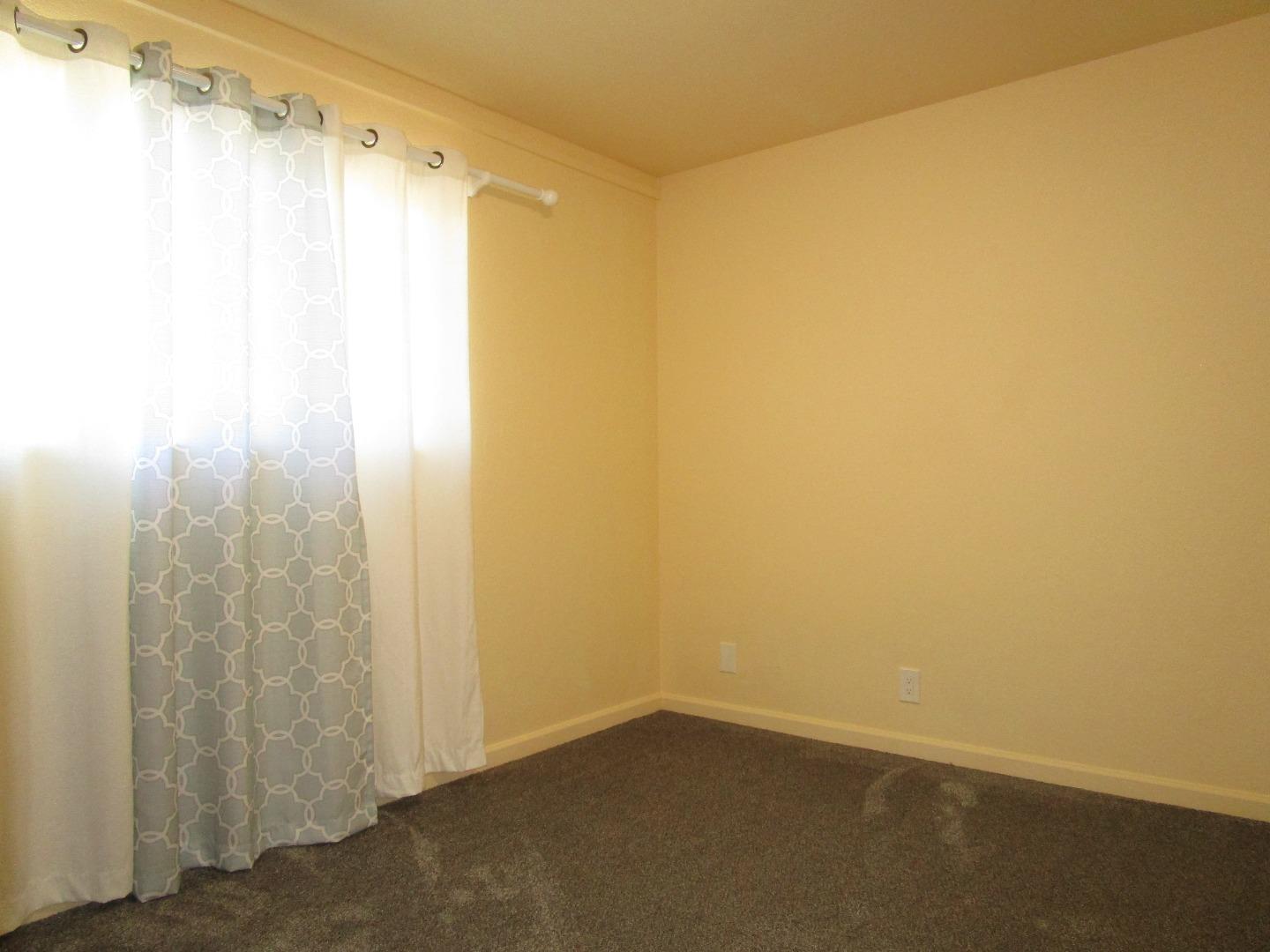 7759 Murray Avenue Gilroy, CA 95020 - Photo 9 of 11 a bathroom with a shower curtain and a window