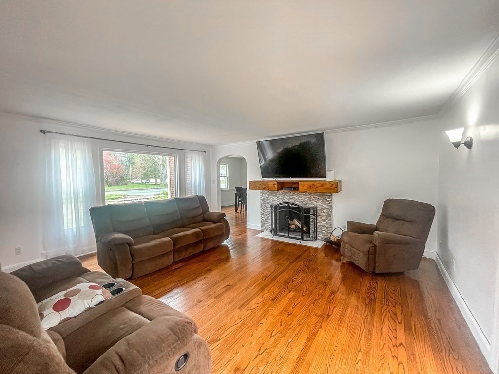 2072 Wilbraham Road Springfield, MA 01129 - Photo 11 of 22 a living room with furniture a fireplace and a flat screen tv