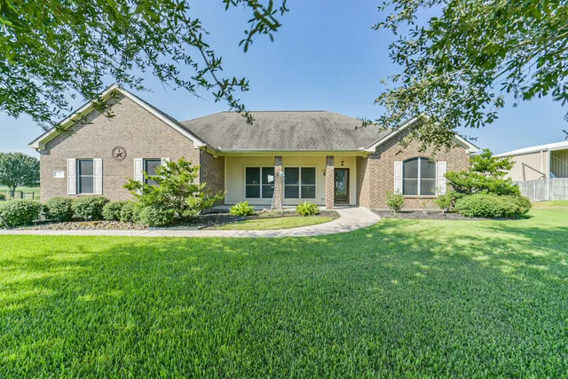 a front view of a house with a yard and porch