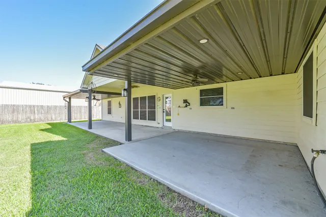 an empty room with a chandelier fan and closet