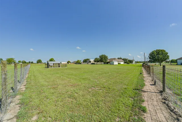 a view of a park with iron fence