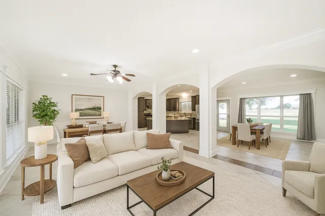 a living room with furniture and a chandelier