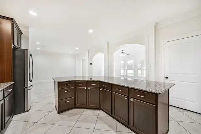 a large kitchen with a granite counter tops and a sink