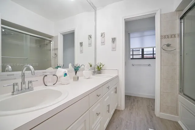 a bathroom with a double vanity sink mirror and double