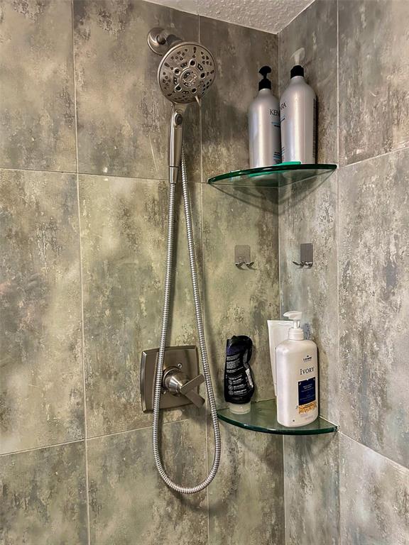 8911 Blind Pass Road, Unit 220 St. Pete Beach, FL 33706 - Photo 55 of 67 a bathroom with a sink and a mirror