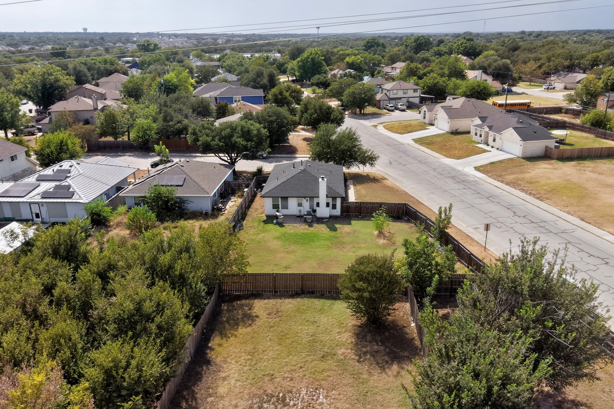 1601 Rusty Nail Loop Round Rock, TX 78681 - Photo 21 of 23 An aerial perspective showcases a spacious backyard enclosed by wooden fencing in a peaceful neighborhood.