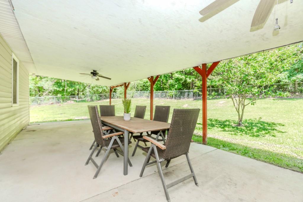 750 Jett Roberts Road Jefferson, GA 30549 - Photo 30 of 37 a view of a patio with table and chairs and floor to ceiling window