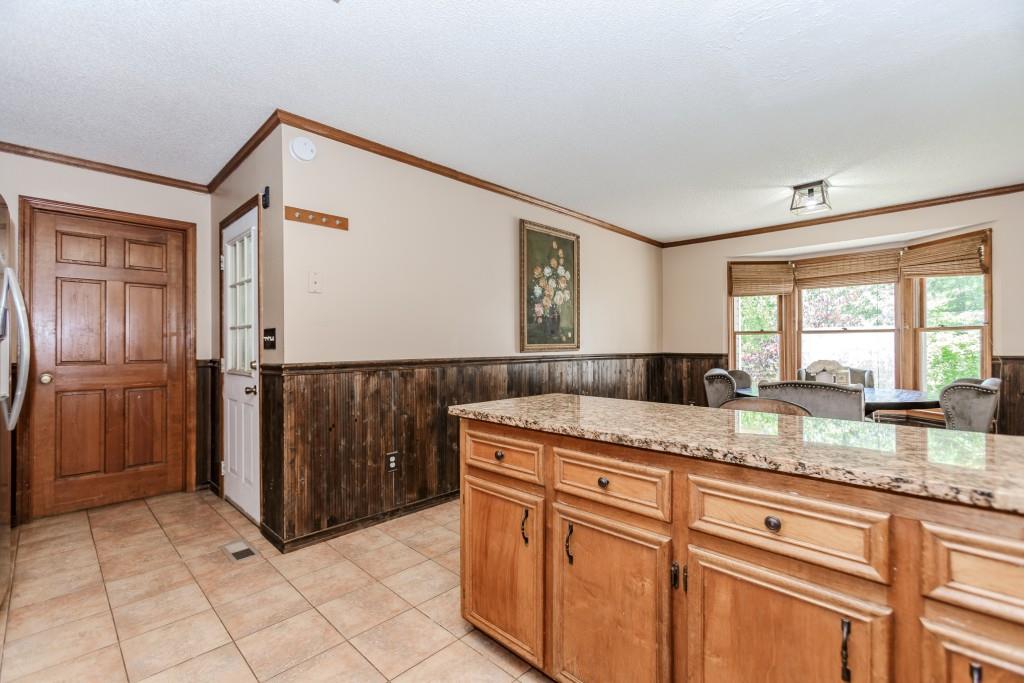 750 Jett Roberts Road Jefferson, GA 30549 - Photo 6 of 37 a kitchen with granite countertop a sink and a refrigerator