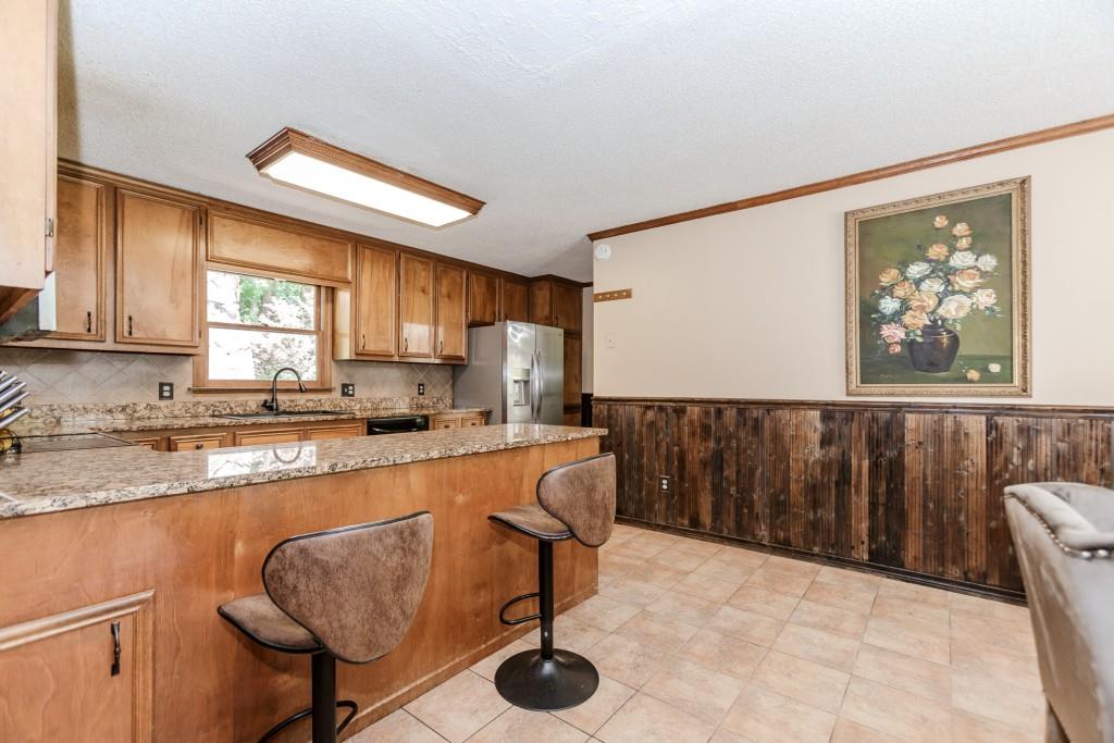 750 Jett Roberts Road Jefferson, GA 30549 - Photo 8 of 37 a kitchen with stainless steel appliances granite countertop a stove a sink and a refrigerator