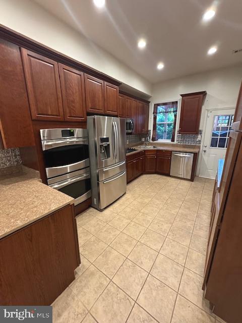 1767 E Street Northeast Washington, DC 20002 - Photo 2 of 8 a kitchen with stainless steel appliances kitchen island granite countertop a refrigerator stove and sink