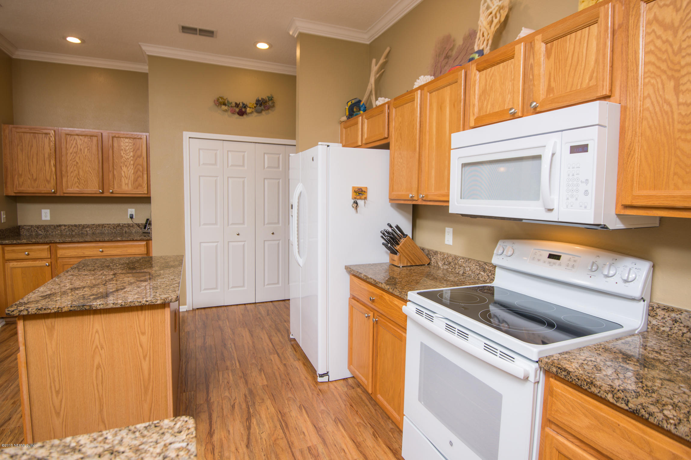 213 Merida Road St. Augustine, FL 32086 - Photo 11 of 34 a kitchen that has a sink and a stove in it