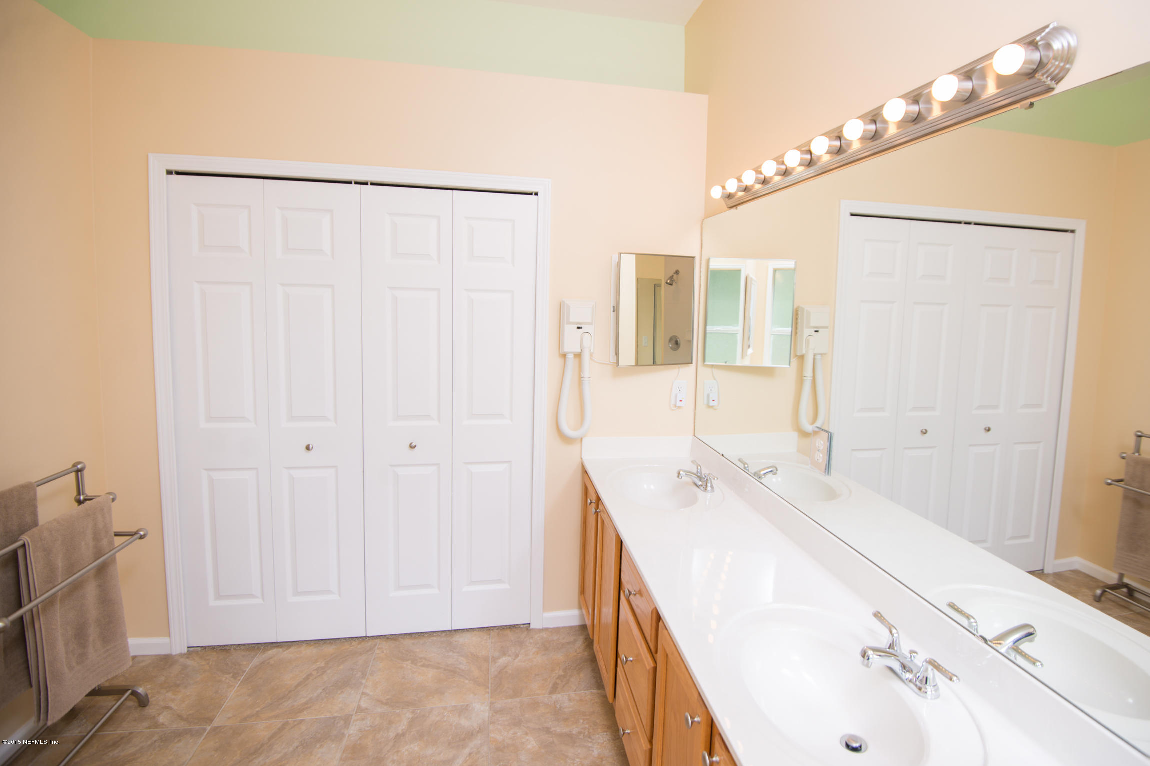 213 Merida Road St. Augustine, FL 32086 - Photo 19 of 34 a spacious bathroom with a double vanity sink and a mirror