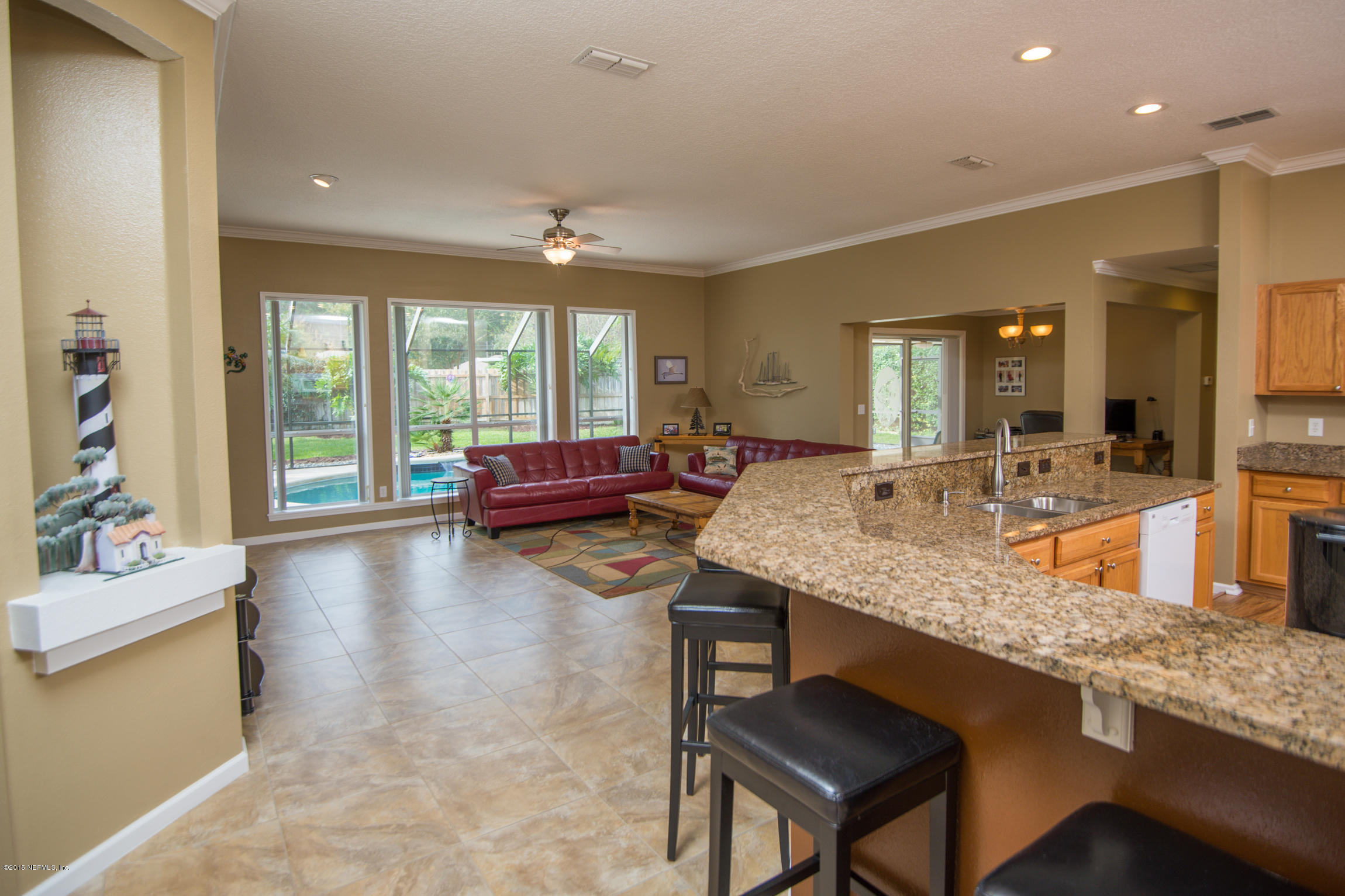 213 Merida Road St. Augustine, FL 32086 - Photo 8 of 34 a living room with granite countertop kitchen island furniture and a sink