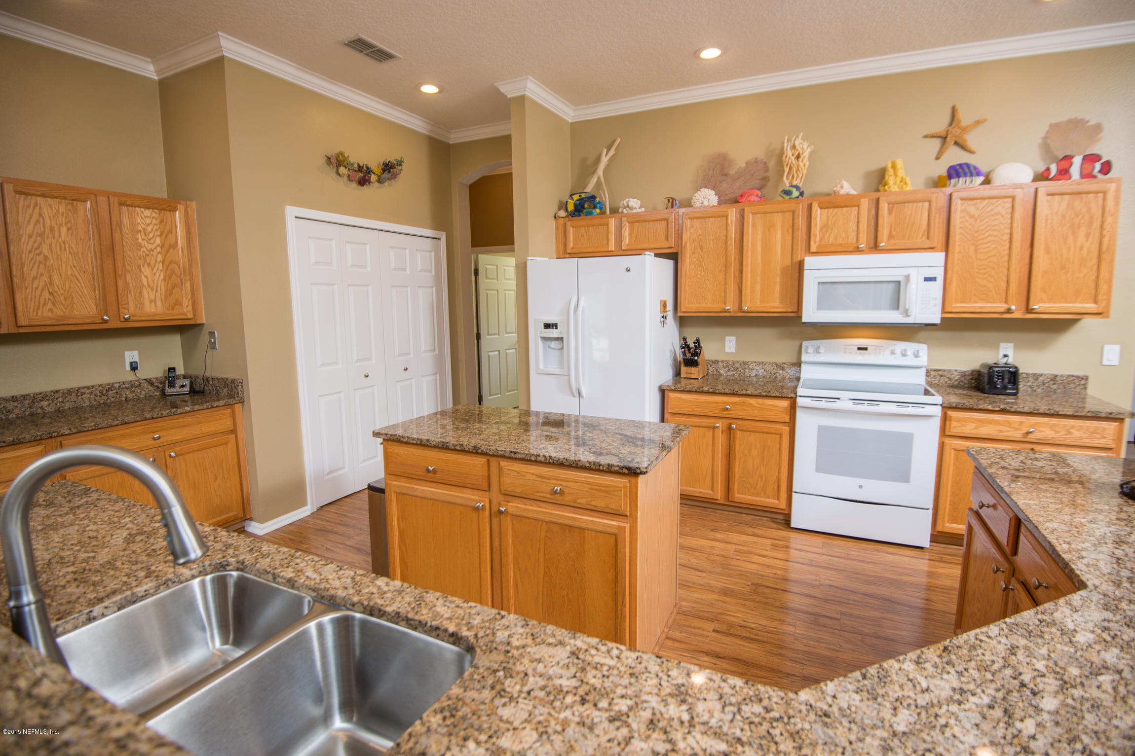 213 Merida Road St. Augustine, FL 32086 - Photo 9 of 34 a kitchen with stainless steel appliances granite countertop a sink a stove and a refrigerator
