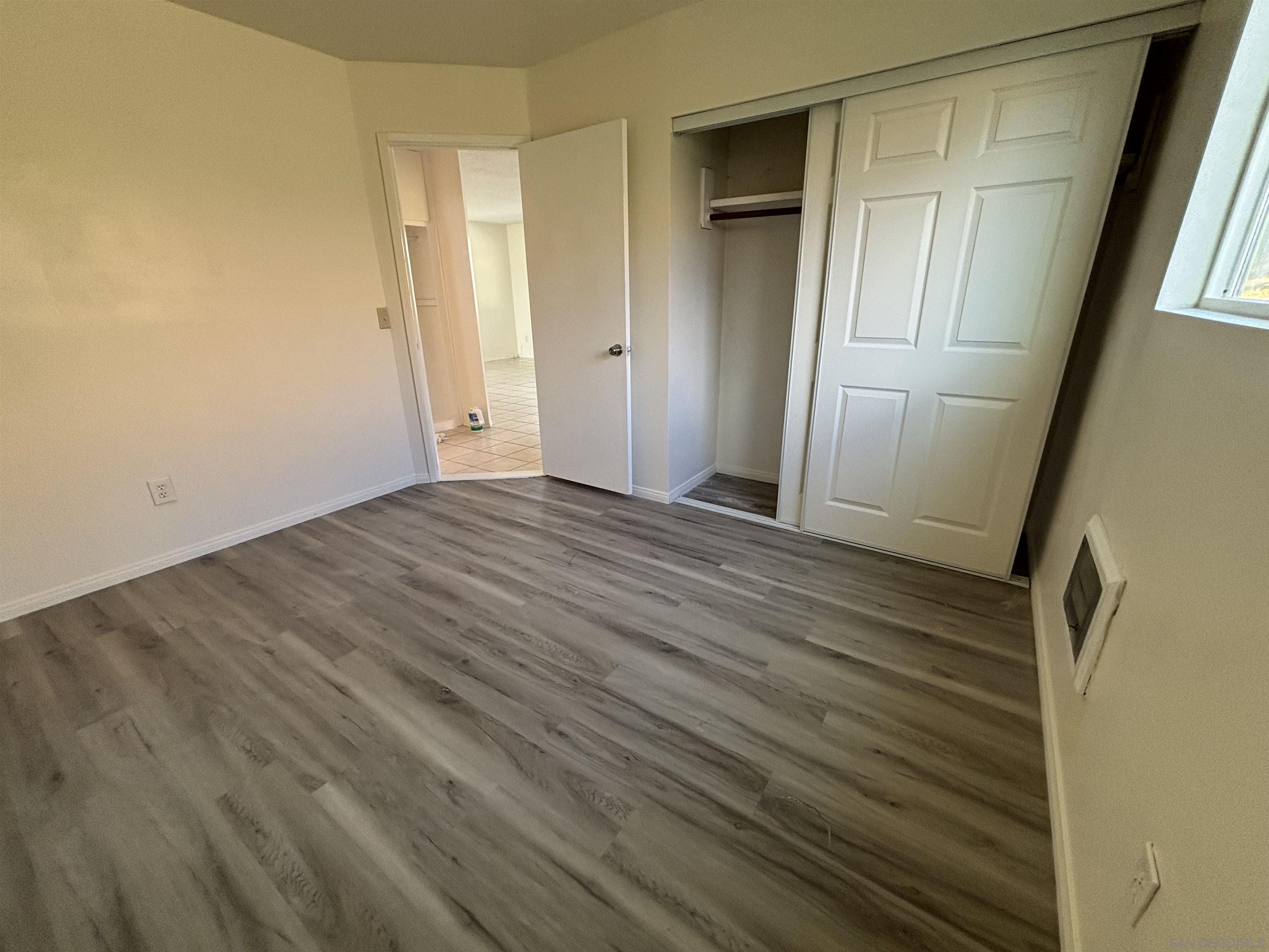 8209 Jema Way Lakeside, CA 92040 - Photo 30 of 40 a view of an empty room with wooden floor and a window
