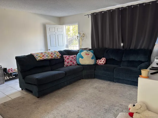 a view of a dining room with furniture and a kitchen