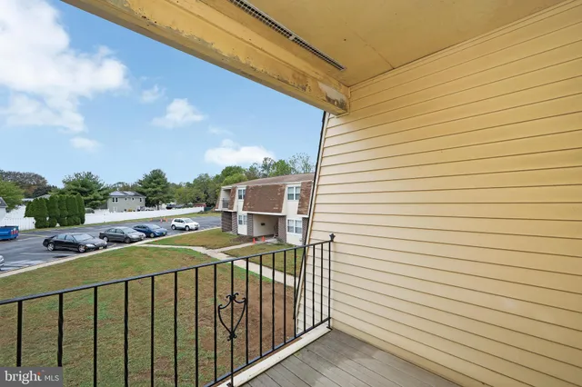 a view of a balcony with wooden floor