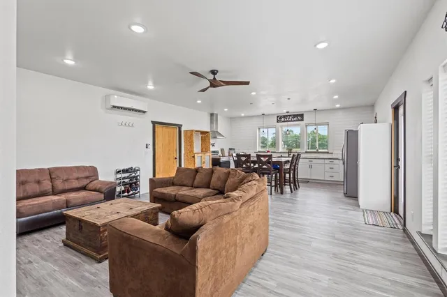 a living room with furniture a rug and white walls