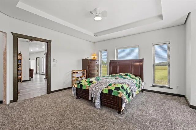 a large white kitchen with a sink and refrigerator