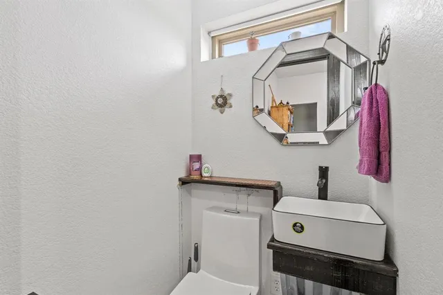 a view of a room with refrigerator and wooden floor