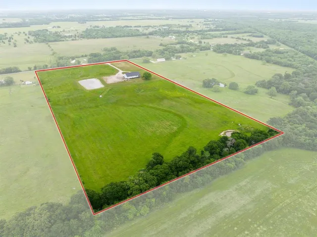 a view of a field with an ocean