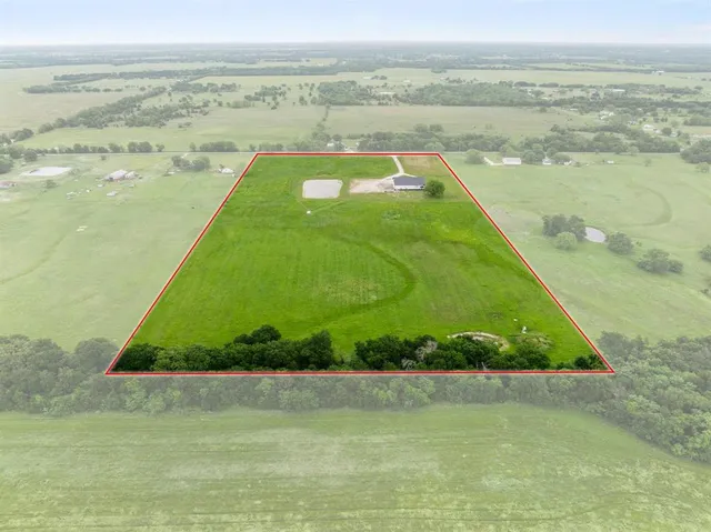 a view of a field with an ocean
