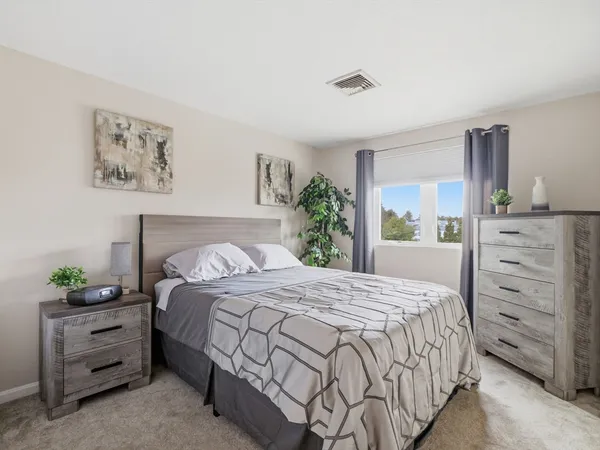 a bedroom with a bed and a window