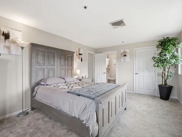 a bedroom with a bed and a table