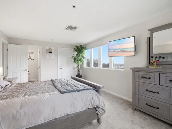 a bedroom with a bed and a dresser in it